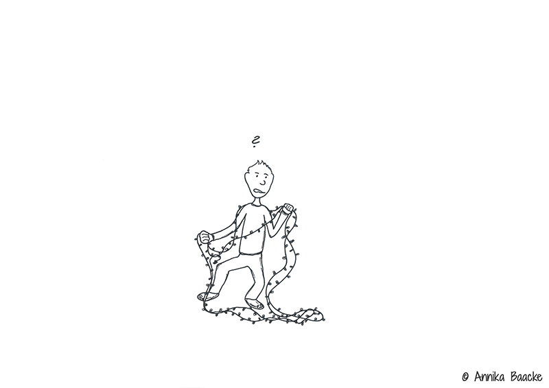 Comicfigur verheddert in einer Lichterkette - Copyright: Annika Baacke